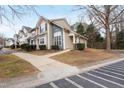 Tan and blue townhome with walkway and street view at 1920 Lost Ln, Raleigh, NC 27603