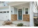 Inviting front entrance with teal door and stonework at 2371 Kettle Falls Sta, Apex, NC 27502
