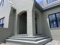 Wide steps lead up to an arched, covered entryway, highlighting the home's solid brick construction and design at 274 Westhampton Dr, Pittsboro, NC 27312