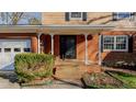 Brick front porch with steps leading to the entrance, featuring columns and landscaping at 3042 Marlborough Rd, Burlington, NC 27215