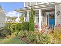 Landscaped front yard with colorful plants and a welcoming porch at 316 Granite Cove Ct, Rolesville, NC 27571