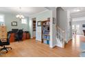 Home office with built-in shelving, hardwood floors, and plenty of natural light at 316 Granite Cove Ct, Rolesville, NC 27571