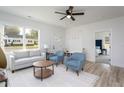 Inviting living room with modern furnishings, light-colored walls, and vinyl flooring with an entry bench near door at 420 E Cedar Ave, Wake Forest, NC 27587