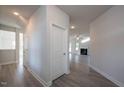 Bright hallway with light gray walls and wood-look flooring, leading to other rooms at 45 River Chapel Dr, Fuquay Varina, NC 27526