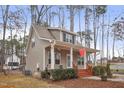 This charming house features a covered front porch and a neatly landscaped yard at 4716 Howe St, Durham, NC 27705