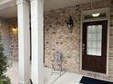 Townhouse front entrance with brick accents and a dark brown door at 4972 Highcroft Dr, Cary, NC 27519