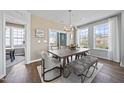 Light-filled dining area with wood table, built-in bench, and access to a sunroom at 604 Market Grove Dr # 200, Wake Forest, NC 27587
