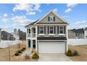 Two-story house with gray siding, balcony, and attached garage at 655 Hawksbill Dr, Franklinton, NC 27525