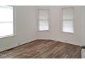 Spacious bedroom with wood flooring and multiple windows at 723 S Washington St, Rocky Mount, NC 27801