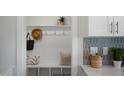 White built-in bench with cubbies and hooks, ideal for storage and organization at 86 Macy Cir, Wendell, NC 27591