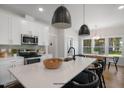 Modern kitchen with white cabinets, stainless steel appliances, and breakfast bar at 86 Macy Cir, Wendell, NC 27591