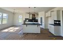 Modern kitchen featuring a center island, stainless steel appliances, and white cabinets at 899 Olive Branch Dr, Smithfield, NC 27577