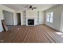 Spacious living room with fireplace, built-in shelving, and large windows offering plenty of natural light at 899 Olive Branch Dr, Smithfield, NC 27577