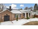 Brick ranch house with covered porch and landscaping, showcasing curb appeal at 927 Bellvue St, Burlington, NC 27217