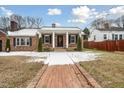 Brick ranch house with covered porch and walkway, inviting entryway at 927 Bellvue St, Burlington, NC 27217