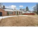Brick house with a snow-covered lawn and walkway, showcasing curb appeal at 927 Bellvue St, Burlington, NC 27217