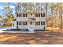 Traditional two-story home featuring black shutters, a white front door, and minimalist landscaping at 1006 Sedwick W Rd, Durham, NC 27713