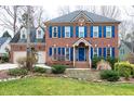 Charming brick home featuring a well-manicured lawn and contrasting blue shutters at 103 Sandy Hook Way, Cary, NC 27513