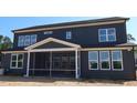 Back exterior view of a two-story home with a covered screened-in porch at 1104 Opal Ln # 104, Durham, NC 27705
