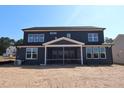 Back exterior view of a two-story home with a covered screened-in porch at 1104 Opal Ln # 104, Durham, NC 27705