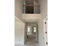 Bright hallway with an open, airy feel, wrought iron railing, and views into other rooms at 1104 Opal Ln # 104, Durham, NC 27705
