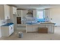 Bright, modern kitchen with white cabinets, a large island, and ample counter space awaiting finishing touches at 1104 Opal Ln # 104, Durham, NC 27705