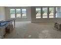 Spacious living room bathed in natural light, featuring large windows offering outdoor views at 1104 Opal Ln # 104, Durham, NC 27705