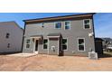 Rear exterior view showcasing gray siding and natural light from multiple windows at 1109 Opal Ln # 71, Durham, NC 27705
