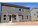 Rear exterior view showcasing gray siding and natural light from multiple windows at 1109 Opal Ln # 71, Durham, NC 27705