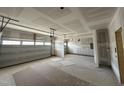 Spacious three-car garage with unfinished walls and ceiling, offering ample storage or parking at 1109 Opal Ln # 71, Durham, NC 27705