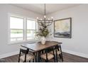 Dining area with wood table, chandelier, and large windows at 121 Weavers Grv Dr, Chapel Hill, NC 27514