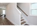 Modern staircase with wood steps and white railing at 111 Weavers Grove Dr # 102, Chapel Hill, NC 27514