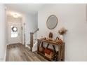 Bright and airy entryway with hardwood floors and a wooden console table at 1141 Logperch Way, Wendell, NC 27591