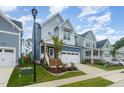 Two-story home with gray siding, white trim, and a charming front porch at 1141 Logperch Way, Wendell, NC 27591