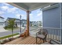 Relaxing front porch with wicker chairs and pumpkins, overlooking the street at 1141 Logperch Way, Wendell, NC 27591