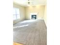 Cozy living room with plush carpeting and fireplace, creating a warm and inviting atmosphere for relaxation at 121 Gratiot Dr, Morrisville, NC 27560