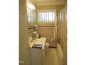 Bathroom with pink tile, shower/tub combo, and a vanity at 1414 Scales St, Raleigh, NC 27608
