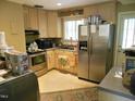 Galley kitchen with stainless steel appliances and ample cabinets at 1414 Scales St, Raleigh, NC 27608