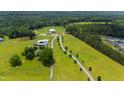 Expansive aerial view showcasing the estate's grounds, featuring lush greenery and a large residence at 14425 Nc-96 N Hwy, Zebulon, NC 27597