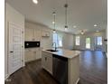 Open-concept kitchen with stainless steel appliances, central island and easy access to living area at 150 W Saltgrass Ln, Smithfield, NC 27577