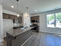 Bright, open kitchen with stainless steel appliances, a granite island, and ample cabinet space at 160 W Saltgrass Ln, Smithfield, NC 27577