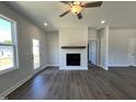 Cozy living room featuring a modern fireplace, neutral walls, and hardwood floors at 160 W Saltgrass Ln, Smithfield, NC 27577