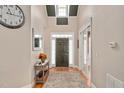 Bright entryway with high ceilings, a dark brown door and hardwood floor at 1704 Little Drake Ave, Willow Springs, NC 27592