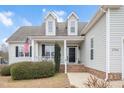 House exterior featuring a covered porch and brick walkway at 1704 Little Drake Ave, Willow Springs, NC 27592