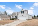 Two-story house with a spacious yard and attached garage at 1704 Little Drake Ave, Willow Springs, NC 27592