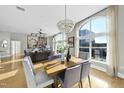 Sunlit dining area with hardwood floors and a modern chandelier at 200 S Dawson St # 406, Raleigh, NC 27601