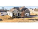Well-maintained home with neutral siding, a manicured lawn and an attached garage at 256 Barbour Farm Ln, Four Oaks, NC 27524