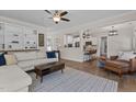Open-concept living room with hardwood floors, comfortable seating, and an adjacent modern kitchen at 467 Joseph Alexander Dr, Fuquay Varina, NC 27526