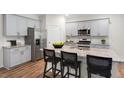 Modern kitchen with gray cabinets, granite countertops and island at 6457 Alfalfa Ln, Wake Forest, NC 27587