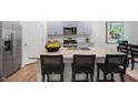 Modern kitchen with gray cabinets, granite countertops, and an island at 6457 Alfalfa Ln, Wake Forest, NC 27587
